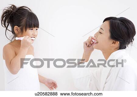 Mother and daughter brushing teeth View Large Photo Image Stock Photo - Mother and daughter brushing teeth. Fotosearch