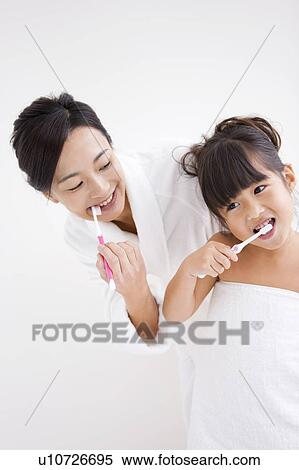 Mother and daughter brushing teeth View Large Photo Image Stock Photography - Mother and daughter brushing teeth. Fotosearch