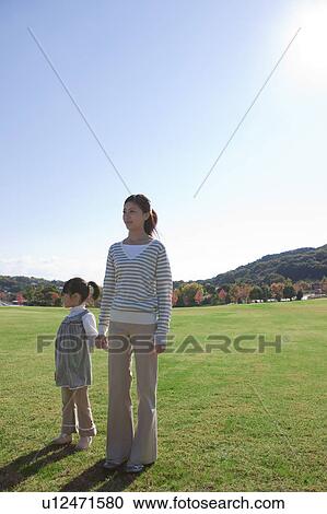 Mother and Daughter Standing in Field View Large Photo Image Stock Image - Mother and Daughter Standing in Field. Fotosearch