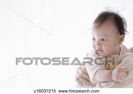 Stock Photography - Mother carrying a baby. Fotosearch