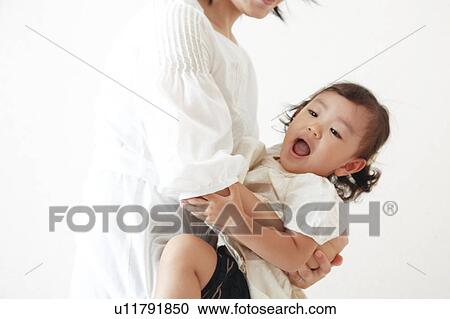 Mother carrying daughter View Large Photo Image Stock Image - Mother carrying daughter. Fotosearch