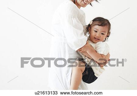 Mother carrying daughter View Large Photo Image Stock Image - Mother carrying daughter. Fotosearch