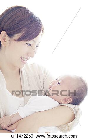 Stock Photo - Mother Carrying Newborn Baby. Fotosearch