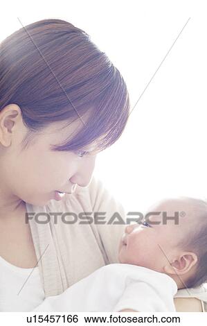 Stock Photograph - Mother Carrying Newborn Baby. Fotosearch