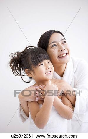 Stock Image - Mother Embracing daughter. Fotosearch