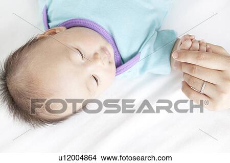 Mother Holding Baby Girl's hand View Large Photo Image Picture - Mother Holding Baby Girl's hand. Fotosearch