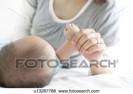 Mother Holding Baby Girl's Hand View Large Photo Image Stock Photo - Mother Holding Baby Girl's Hand. Fotosearch