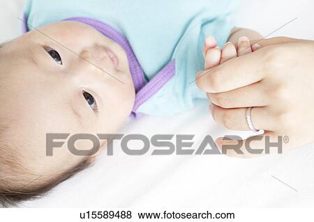 Mother Holding Baby Girl's hand View Large Photo Image Stock Photo - Mother Holding Baby Girl's hand. Fotosearch