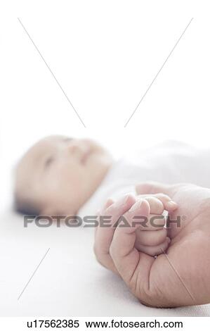 Stock Photography - Mother Holding Baby's Hand. Fotosearch