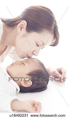 Stock Image - Mother Kissing Baby Boy. Fotosearch