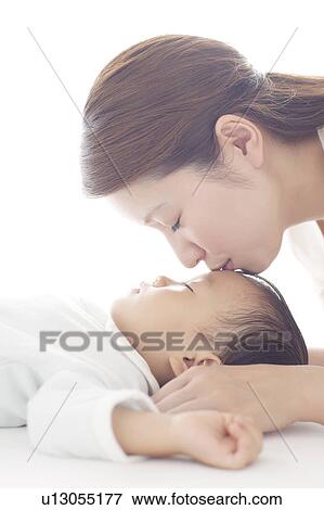 Stock Photo - Mother Kissing Baby Boy. Fotosearch