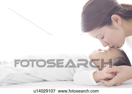 Stock Photo - Mother Kissing Baby Boy. Fotosearch