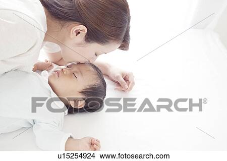 Mother Kissing Baby's Forehead View Large Photo Image Picture - Mother Kissing Baby's Forehead. Fotosearch
