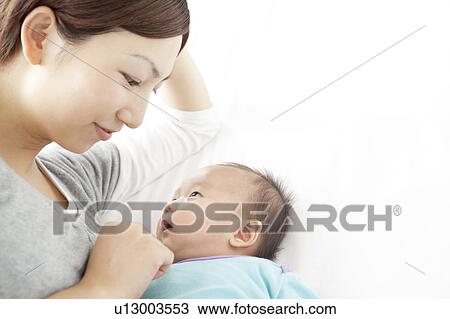Stock Image - Mother Looking at Baby Girl. Fotosearch