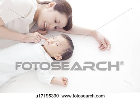 Stock Image - Mother Touching Sleeping Boy. Fotosearch