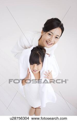 Mother wiping daughter's hair View Large Photo Image Picture - Mother wiping daughter's hair. Fotosearch