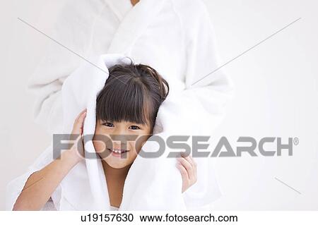 Stock Image - Mother wiping daughter's hair. Fotosearch