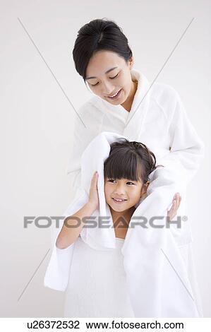Mother wiping daughter's hair View Large Photo Image Stock Image - Mother wiping daughter's hair. Fotosearch