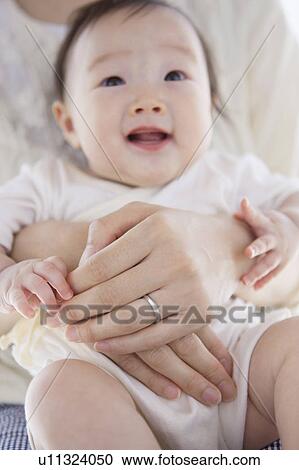 Stock Image - Mother with baby on a lap. Fotosearch