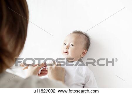 Stock Image - Newborn Baby Looking at Mother. Fotosearch