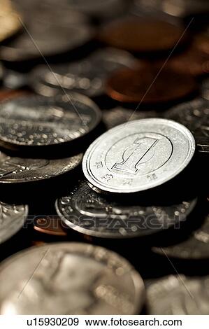 Stock Photo - One Yen Coin and US Coins. Fotosearch