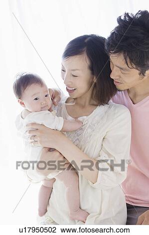 Stock Image - Parents with baby. Fotosearch