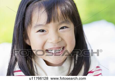 Stock Photo - Portrait of a happy girl. Fotosearch