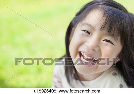 Stock Photography - Portrait of a happy girl. Fotosearch