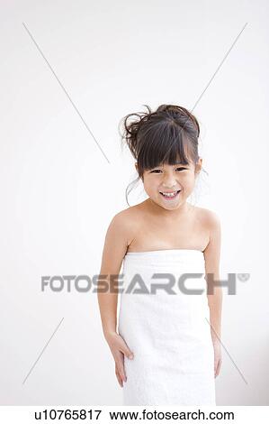 Stock Photo - Portrait of girl wrapped in towel. Fotosearch