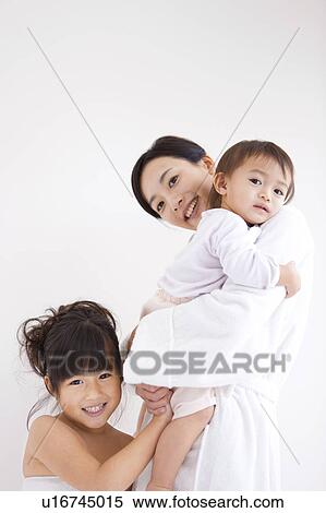 Stock Photography - Portrait of mother and daughters. Fotosearch