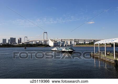 Stock Photograph - Rainbow bridge and Skyline of Chuo ward, Tokyo, Honshu, Japan. Fotosearch