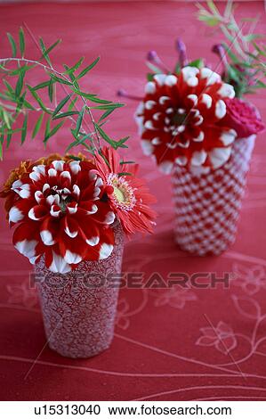 Stock Image - Red Flowers in Red Vase Placed on Red Cloth. Fotosearch