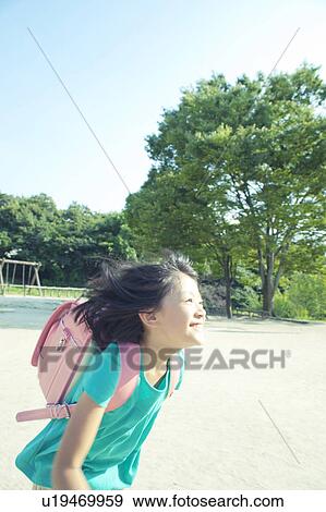 Stock Photo - Schoolgirl in Park. Fotosearch