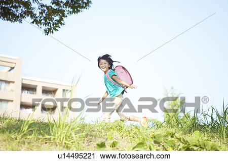 Stock Image - Schoolgirl Running in Field. Fotosearch