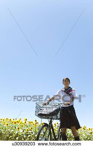 Stock Image - Schoolgirl with Bicycle. Fotosearch