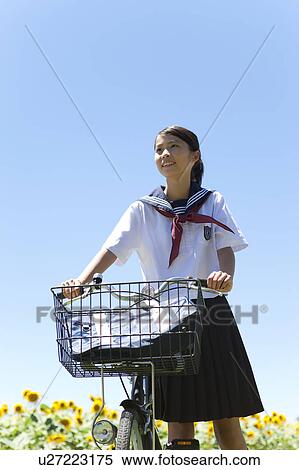 Stock Photography - Schoolgirl with Bicycle. Fotosearch