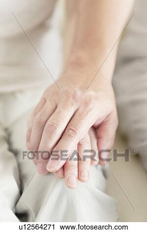 Stock Image - Senior Couple Holding Hands. Fotosearch