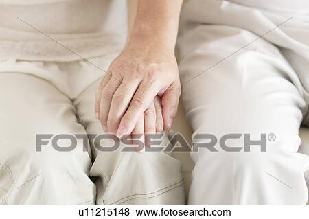 Stock Photo - Senior Couple Holding Hands. Fotosearch