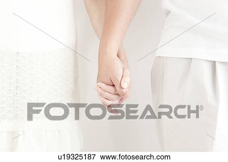 Stock Photo - Senior Couple Holding Hands. Fotosearch