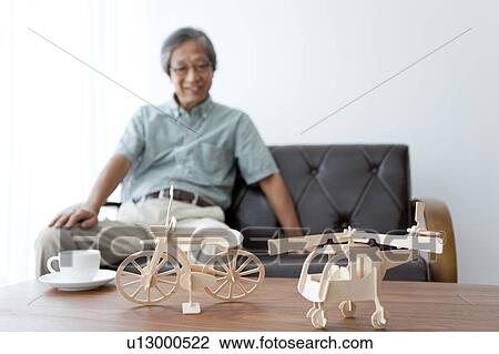 Stock Image - Senior Man and Model Bicycle and Helicopter. Fotosearch