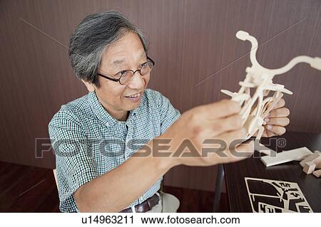 Senior Man Building Wooden Helicopter Model View Large Photo Image Stock Image - Senior Man Building Wooden Helicopter Model. Fotosearch