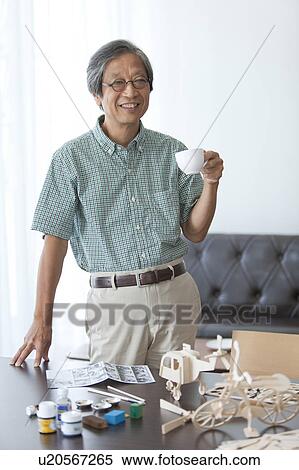 Senior Man Having Coffee Break From Building Wooden Models View Large Photo Image Stock Photography - Senior Man Having Coffee Break From Building Wooden Models. Fotosearch