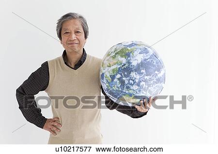 Stock Photo - Senior Man Holding Globe. Fotosearch