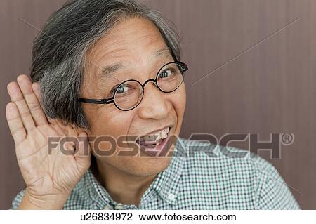 Stock Image - Senior Man Listening. Fotosearch