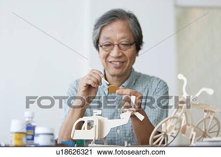 Senior Man Painting Wooden Models View Large Photo Image Stock Image - Senior Man Painting Wooden Models. Fotosearch