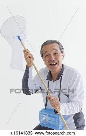 Stock Image - Senior Man with Butterfly Net. Fotosearch