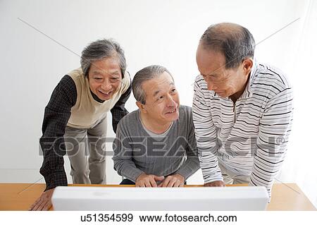 Stock Photo - Senior Three Men at Computer. Fotosearch