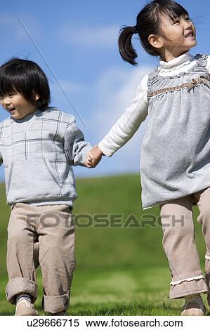 Stock Photography - Sister and Brother Holding Hands. Fotosearch