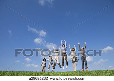 Stock Image - Three Generation Family Jumping. Fotosearch