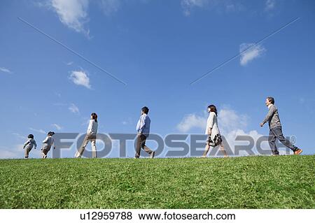 Stock Photo - Three Generation Family Walking in Field. Fotosearch